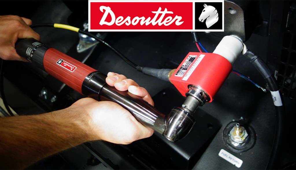 A skilled technician using a Desoutter industrial electric screwdriver from Arle Compressors of Florida for precision assembly work.